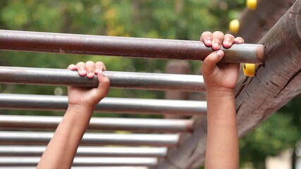 Kids climbing on playground monkey bars at park - Powered by Adobe