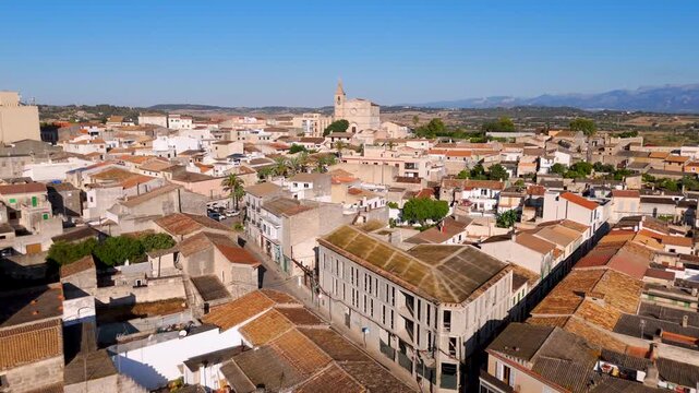 Aerial Drone Wide Shot Flying Over Rooftops Of Santa Margalida Town In Mallorca, Spain At Sunrise