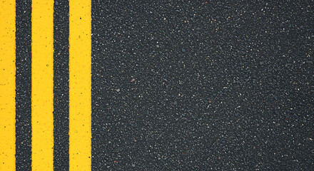Close up overhead view of bright yellow double traffic lines painted on a textured dark asphalt road surface creating a bold graphic pattern