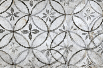 Gray stone floor with circular floral pattern design