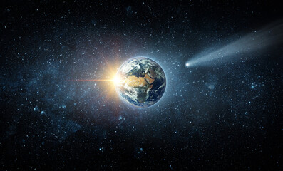 Comet, asteroid, meteorite flying to the planet Earth.  Glowing asteroid and tail of a falling comet threatening the safety of the Earth.  Elements of this image furnished by NASA.