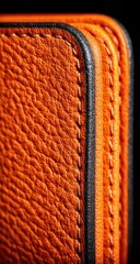 Close-up of orange leather with stitching