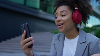 Young woman enjoying video call with headphones - Powered by Adobe
