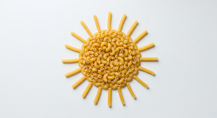 Abstract sun symbol design made with golden macaroni pasta pieces arranged in circular creative food concept