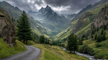 A winding asphalt road through a lush green mountain valley under a dramatic, cloudy sky with sunlight breaking through