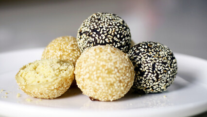 Onde-onde or sesame balls on a white plate. A famous snack cake in Indonesia.