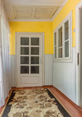 Old white wooden door and window with stained glass