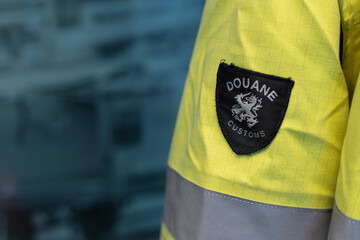 Close-up of official Dutch customs uniform patch showing Douane Customs identification