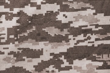 Texture of Dark green pixel camouflage military uniform textile cloth with folds