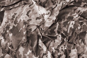 Texture of Dark green pixel camouflage military uniform textile cloth with folds