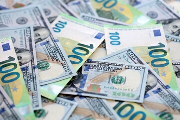Big pile of Euro and USD banknotes. Many european and united states dollars
