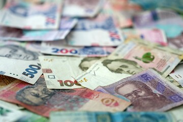Big amount of different ukrainian hryvnia currency money bills in pile