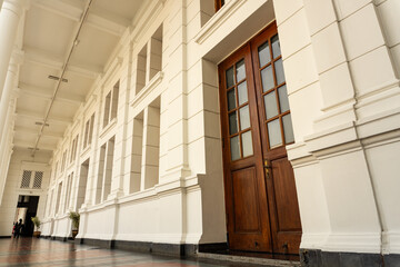 Walking through a Colonnade with a Door and White Building Facade