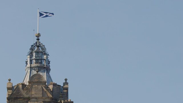 Scottish Flag Waving Atop Historic Castle Tower