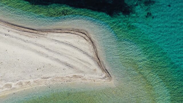Agios Pavlos Beach with white sand and turquoise water on Amorgos Island, Greece, soft gradien water backdrop, drone top down overview
