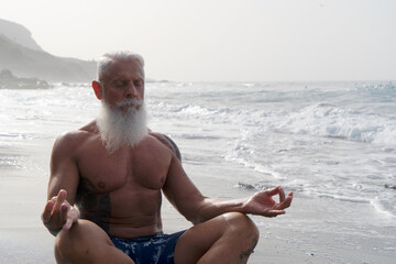 Happy fit senior man relaxing and breathing, enjoy life and buthing in the sea. Elderly healthy people lifestyle and sport activity