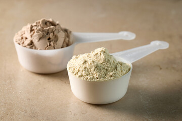 protein powder in scoops. dry mixture for preparation of sporting or dietary drink.
