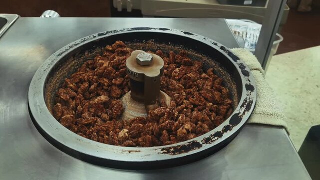 close up roasted candied nuts spinning in roaster inside buc ees texas