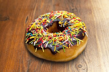 Tasty fresh sweet Donut on wooden desk