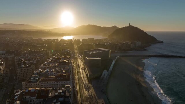 Aerial hyperlapse of San Sebastian coastline and La Concha Bay at sunset in Basque Country, Spain