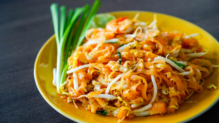 Pad Thai is a Thai noodle stir fry with a sweet-savoury-sour sauce scattered with crushed peanuts.