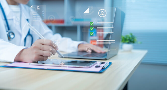 Doctor using digital pen with medical interface on tablet and laptop electronic health record data management smart healthcare technology
