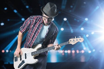 Obraz premium Bassist's music man hands playing on guitar