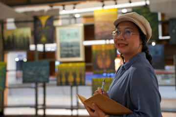 Woman observing artwork in modern art gallery. Captures moment of thoughtful appreciation, ideal for themes of creativity, inspiration, education, and cultural exploration.