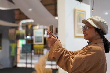 Woman observing artwork in modern art gallery. Captures moment of thoughtful appreciation, ideal...