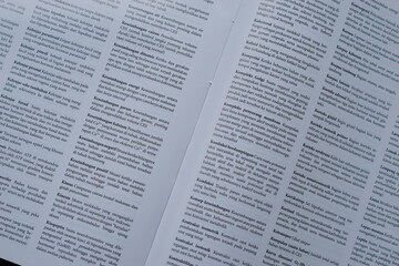 Obraz premium A close-up of an open medical textbook, showing detailed text and diagrams about human physiology and biology. This image represents study, education, research, and the journey of a medical student.