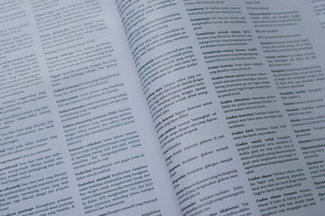 Obraz premium A close-up of an open medical textbook, showing detailed text and diagrams about human physiology and biology. This image represents study, education, research, and the journey of a medical student.