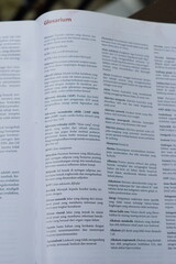 Obraz premium A close-up of an open medical textbook, showing detailed text and diagrams about human physiology and biology. This image represents study, education, research, and the journey of a medical student.