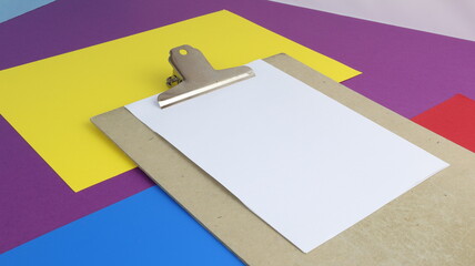 Blank sheet of paper held by clipboard with colored background and copy space is part of a series