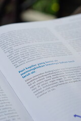 A close-up of an open medical textbook, showing detailed text and diagrams about human physiology and biology. This image represents study, education, research, and the journey of a medical student.