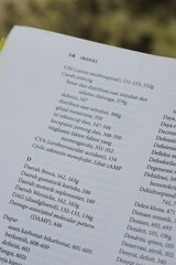 Obraz premium A close-up of an open medical textbook, showing detailed text and diagrams about human physiology and biology. This image represents study, education, research, and the journey of a medical student.