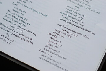 A close-up of an open medical textbook, showing detailed text and diagrams about human physiology and biology. This image represents study, education, research, and the journey of a medical student.