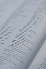 A close-up of an open medical textbook, showing detailed text and diagrams about human physiology...