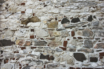 Background stone wall close-up. Old wall made of uneven stones