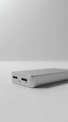 Minimalist communication device with a sleek design and polished surface on a neutral backdrop.
