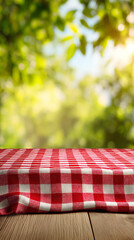 A red and white checkered tablecloth covers a wooden table, with a blurred green foliage background suggesting a picnic or outdoor setting.