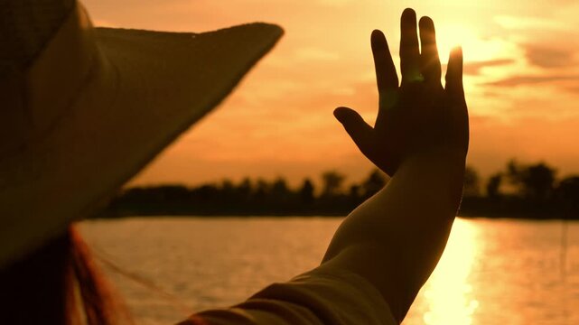 With her hand blocking the sunlight, this image reflects seeking comfort, respecting boundaries, enjoying nature, valuing wellness, and the harmony between humanity and the natural world.
