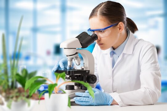 Science portrait, of young woman and microscope
