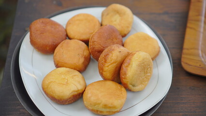 Plate of Homemade Fried Donuts on a Wooden Table