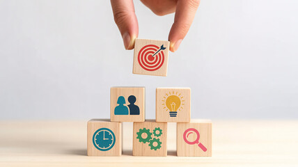 Achieve business goals with teamwork, ideas, planning, and research as hand sets wooden target block