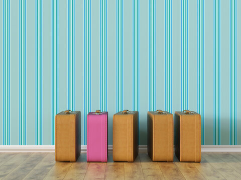 Pink suitcase standing out among luggage in a row indoors