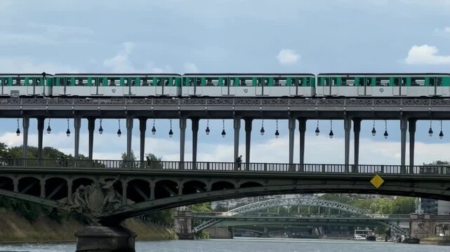 Dynamic 4K traveling video of Paris metro crossing Seine River bridge.