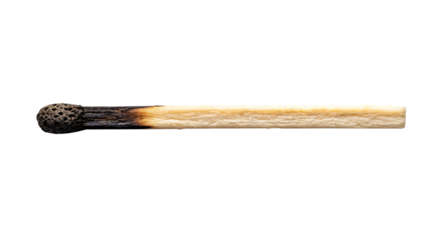 A matchstick with burnt tip and ash residue