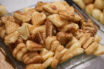 mini waffle cakes served on a large plate.