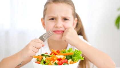 Displeased child eating vegetables