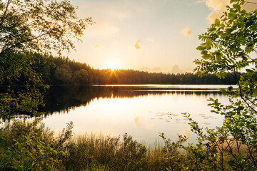 Sunset Over a Tranquil Lake – Golden Evening Reflection
